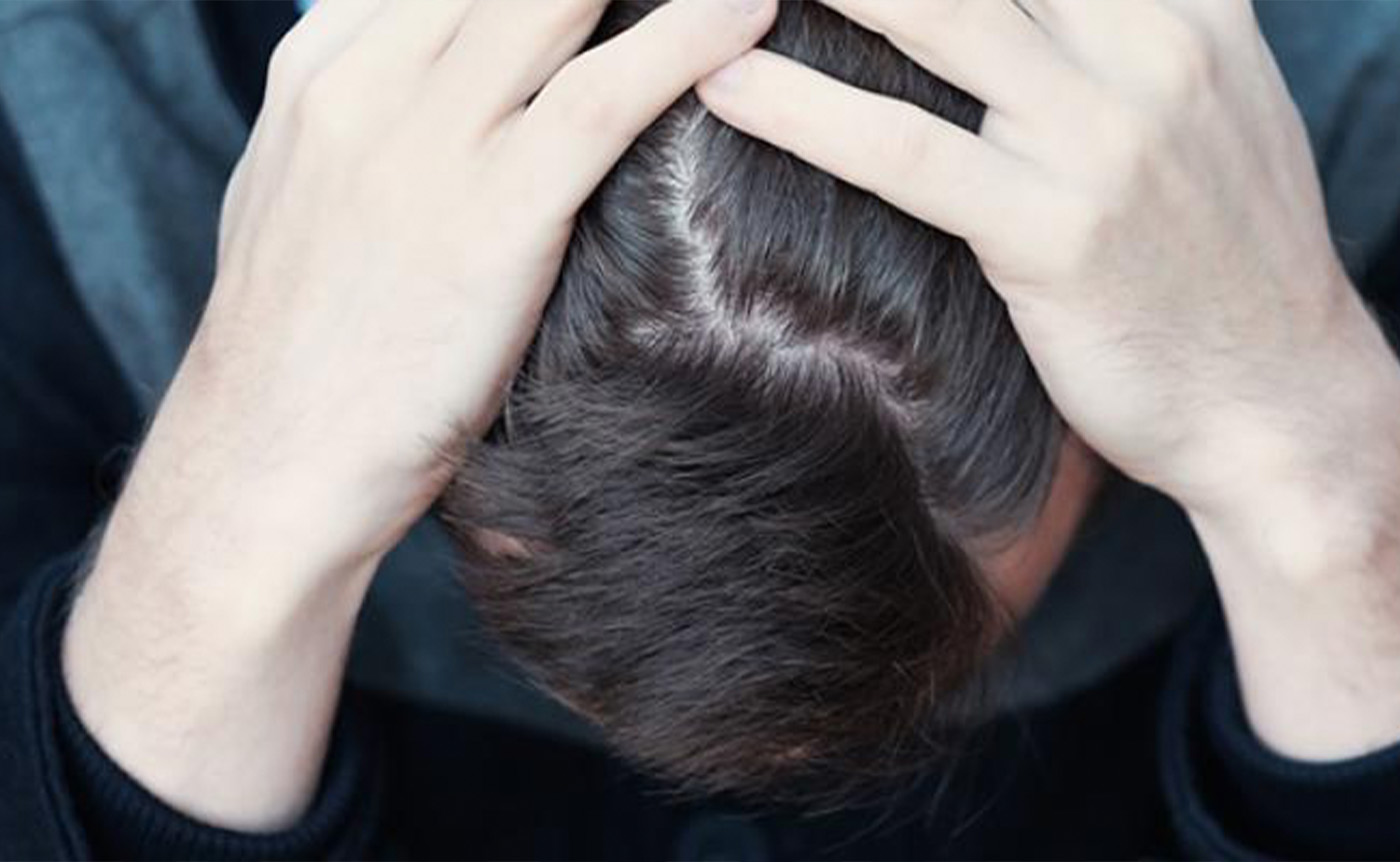 The stressed male sitting