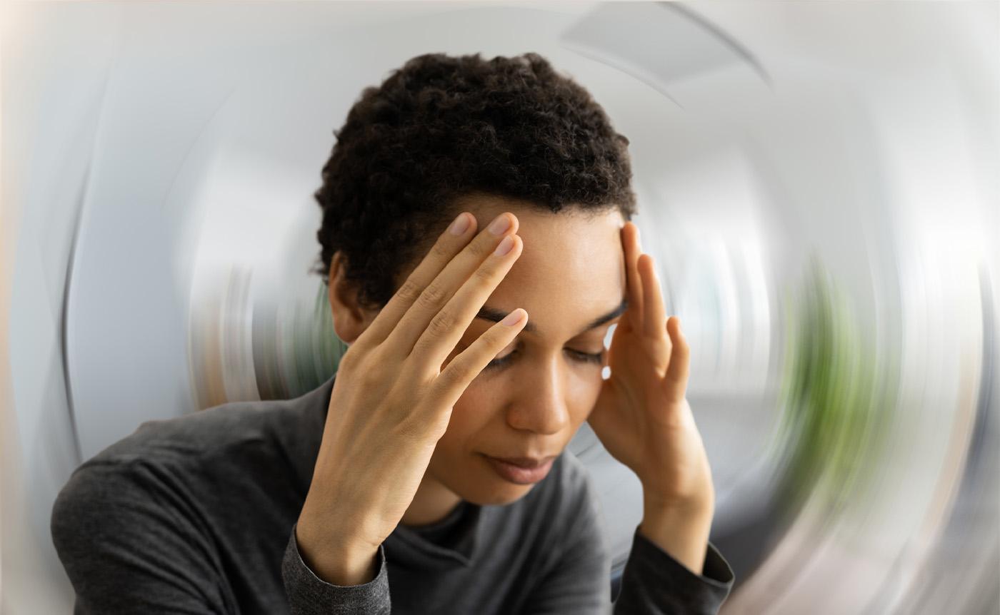 A woman holding her forehead
