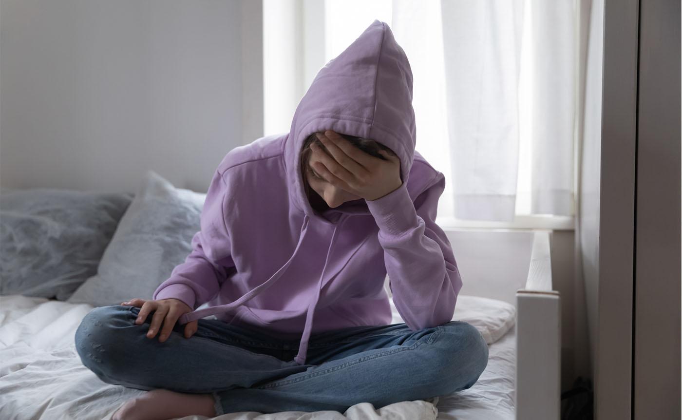 A teenage sad girl sitting